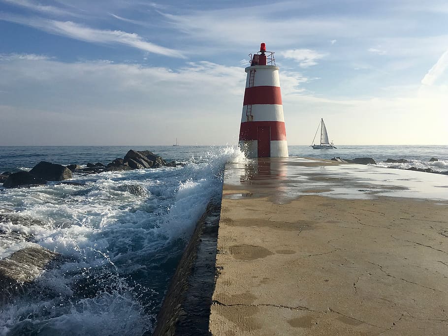 clouds, sky, ocean, lighthouse, pier, rocks, splashes, water HD wallpaper
