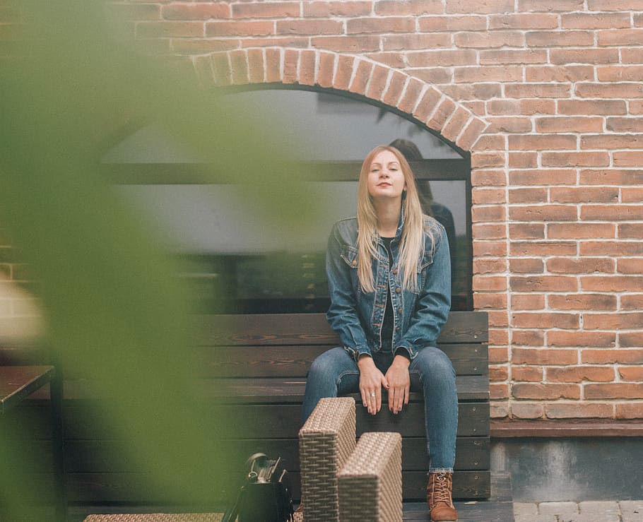 Woman Sitting on Bench Near Wall, beautiful, blur, brickwall HD wallpaper