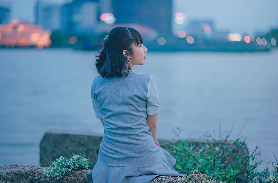 Woman Wearing Gray Dress Sitting Near Body of Water, back view HD wallpaper