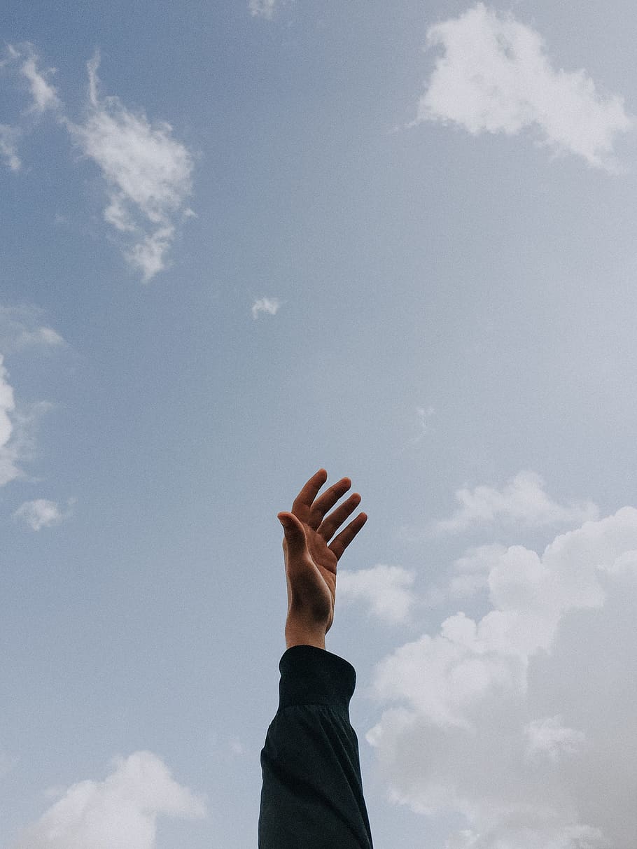 person raising left hand under cloudy sky at daytime, white, minimal HD wallpaper