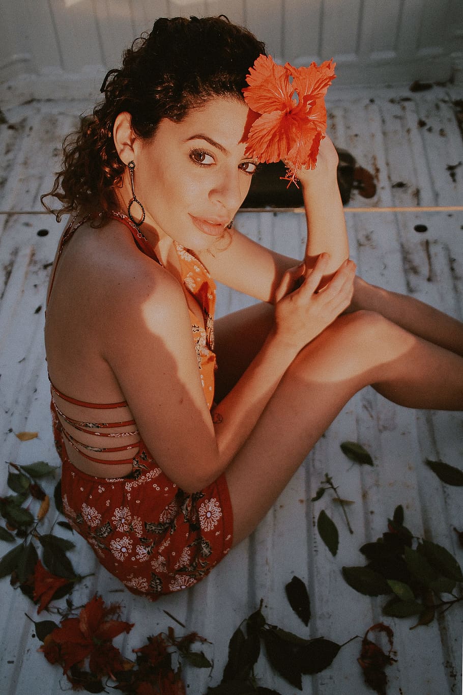 Woman Sitting on White Surface Holding Red Hibiscus Flower, attractive HD wallpaper