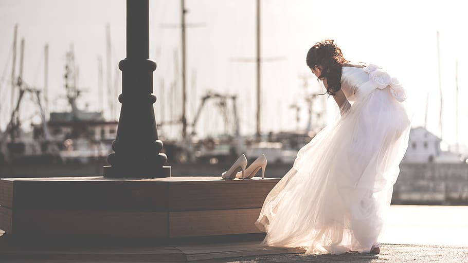 woman taking off her shoe near post, bride, port, dress, bride shoes, HD wallpaper