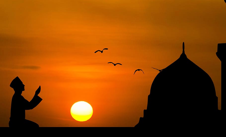 Silhouette of man praying with sunset background., islamic, prayer