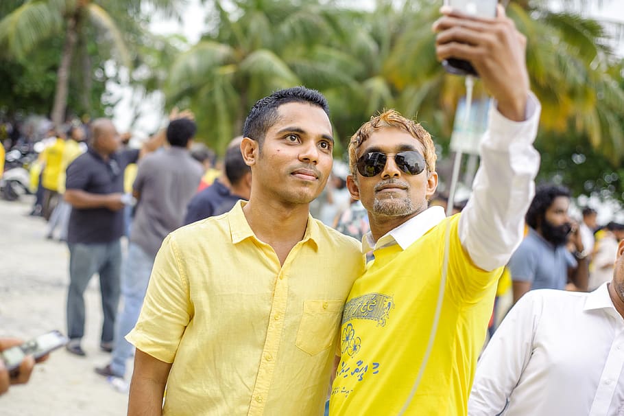 Two Men Taking Selfie, cellphone, crowd, daylight, daytime, focus HD wallpaper