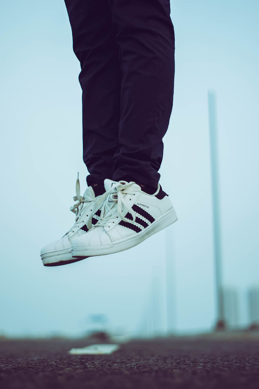 Person Wearing Pair of White Adidas Superstar Shoes, fashion