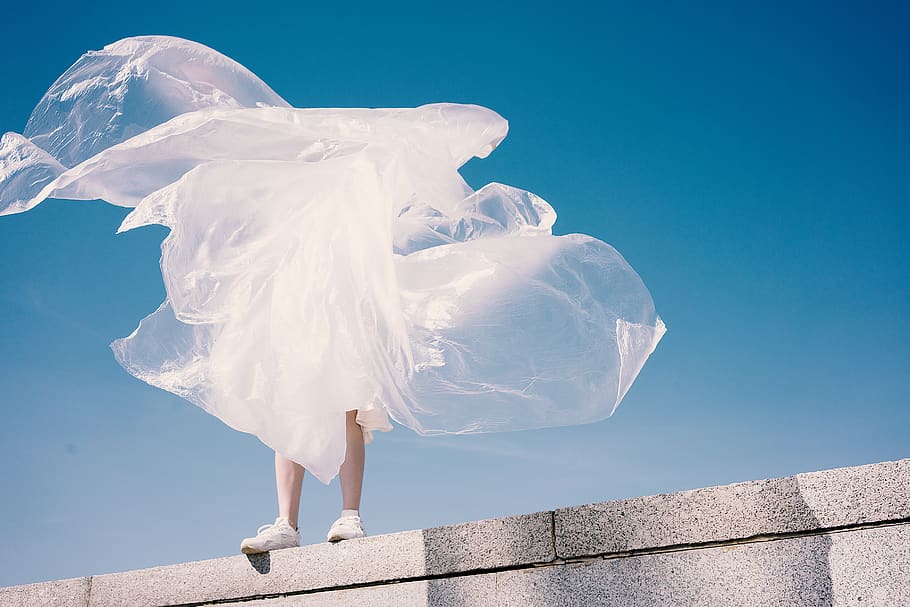 person holding plastic while standing on wall, blue, sky, white color HD wallpaper