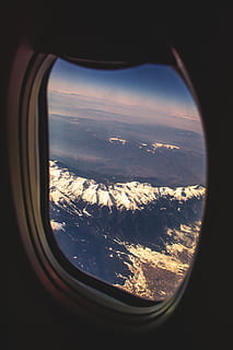 mountain range view from inside plane, window, porthole, mountains HD wallpaper