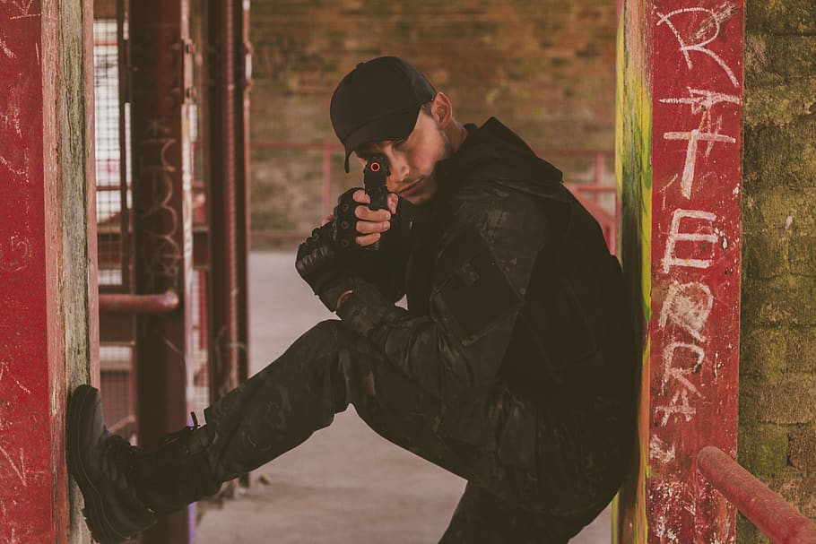 Man Holding Gun, cap, close-up, pose, toy gun, urban, vandalism HD wallpaper