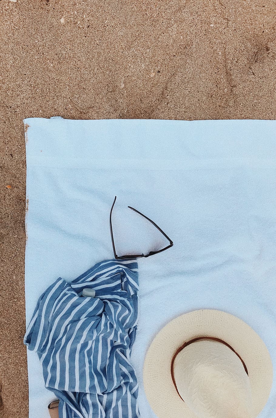 flay lay photography of blanket, summer hat, and sunglasses on fleece towel HD wallpaper
