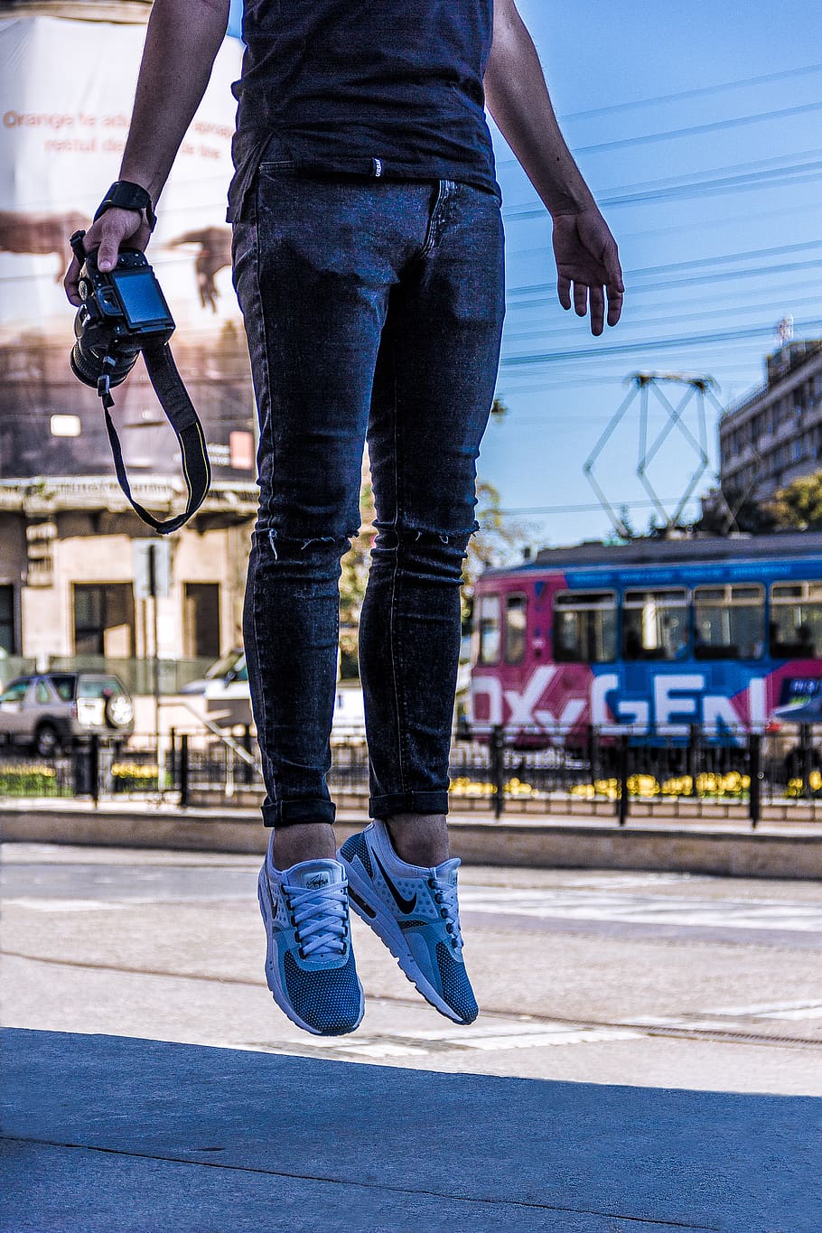 Person Jumping While Holding Camera, man, road, street, one person HD wallpaper