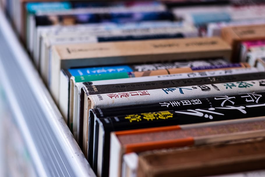 assorted-title books on shelf, selective focus, close-up, technology HD wallpaper
