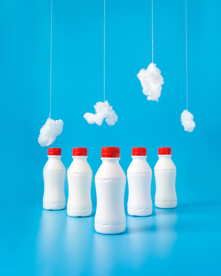 five white plastic bottles on blue surface, indoors, no people HD wallpaper