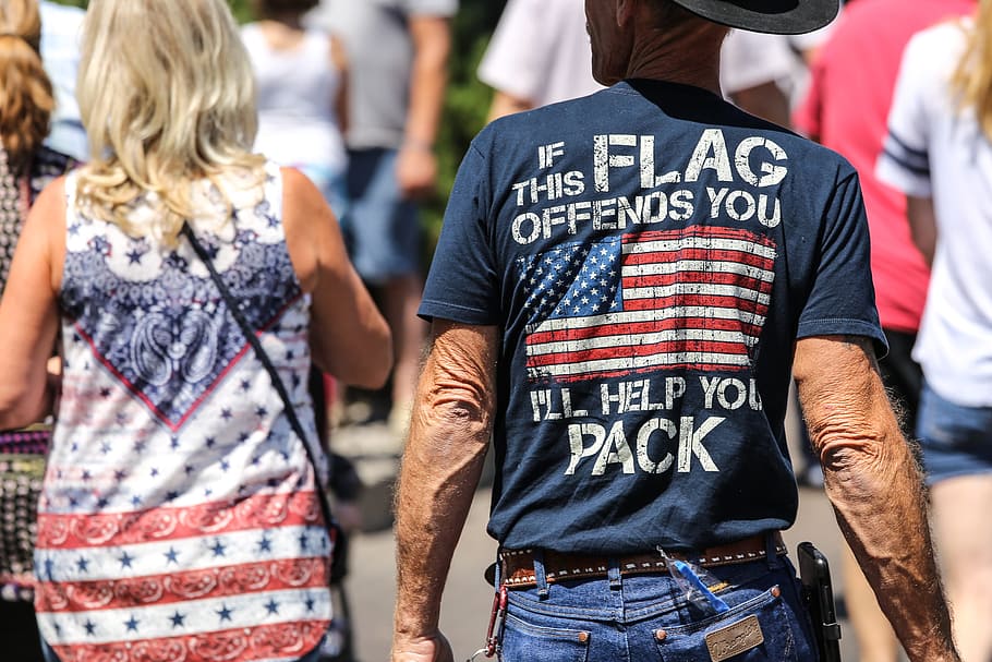 Guy wearing a shirt that says If this flag offends you I ll help you pack.