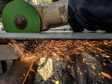 Person Using Green And Grey Angle Grinder On Sheet Of Metal, construction HD wallpaper