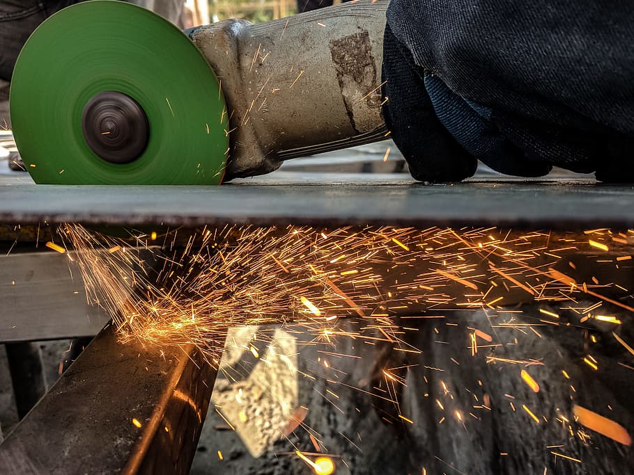 Person Using Green And Grey Angle Grinder On Sheet Of Metal, construction HD wallpaper