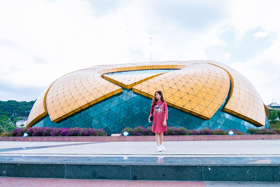 Woman Standing Near Blue and Yellow Dome Under White Cloudy Skies at Daytime HD wallpaper