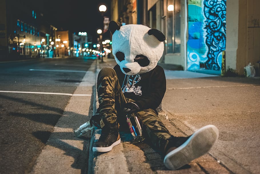 man wearing panda costume leaning on post, person, mask, drunk