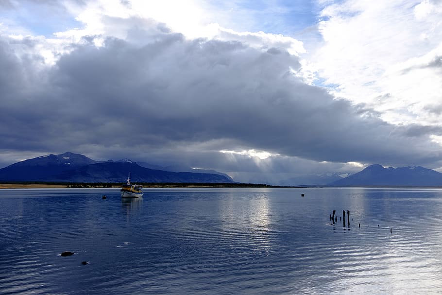 puerto natales, chile, mountain range, boat, golden hour, snow peaks