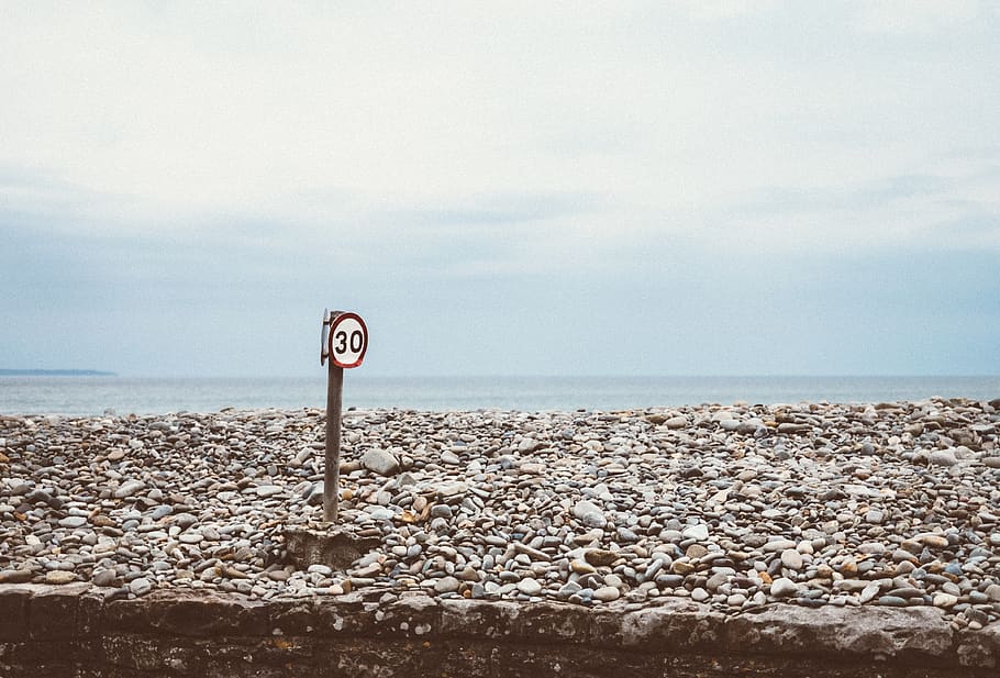 rocks, sign, sky, ocean, speed, stone, pebbles, warning, law HD wallpaper