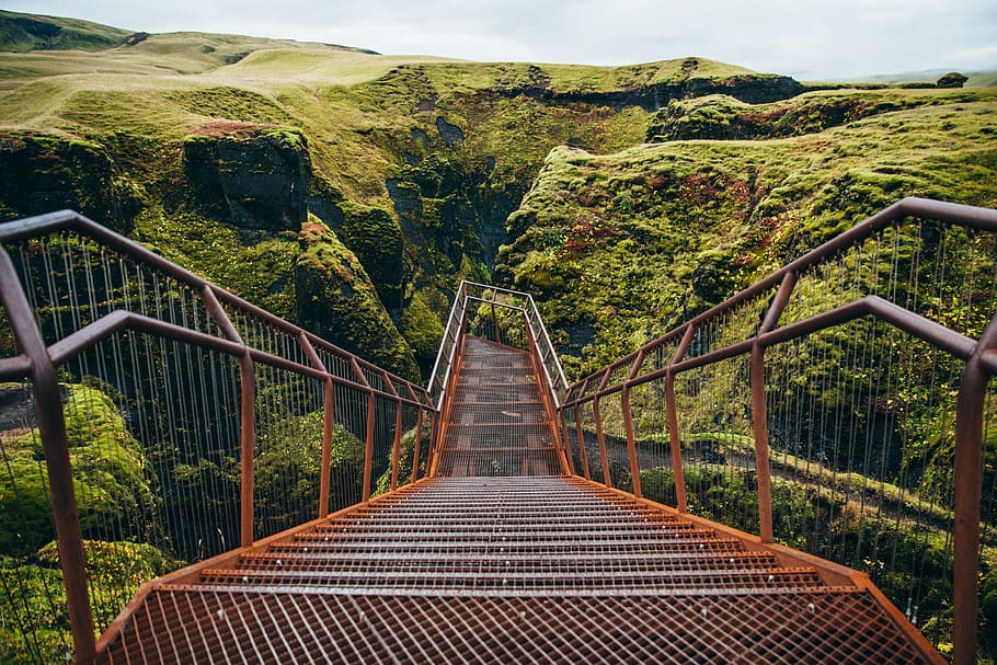 A viewing platform with staircase surrounded by green cliffs HD wallpaper