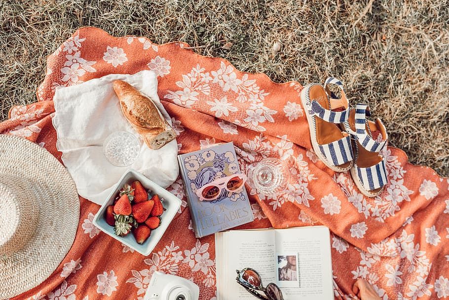 top angle photography of strawberries beside book, apparel, clothing