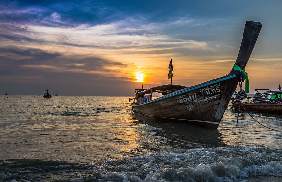 Photo of Brown Boat at Sea during Golden Hour, beach, boats, clouds