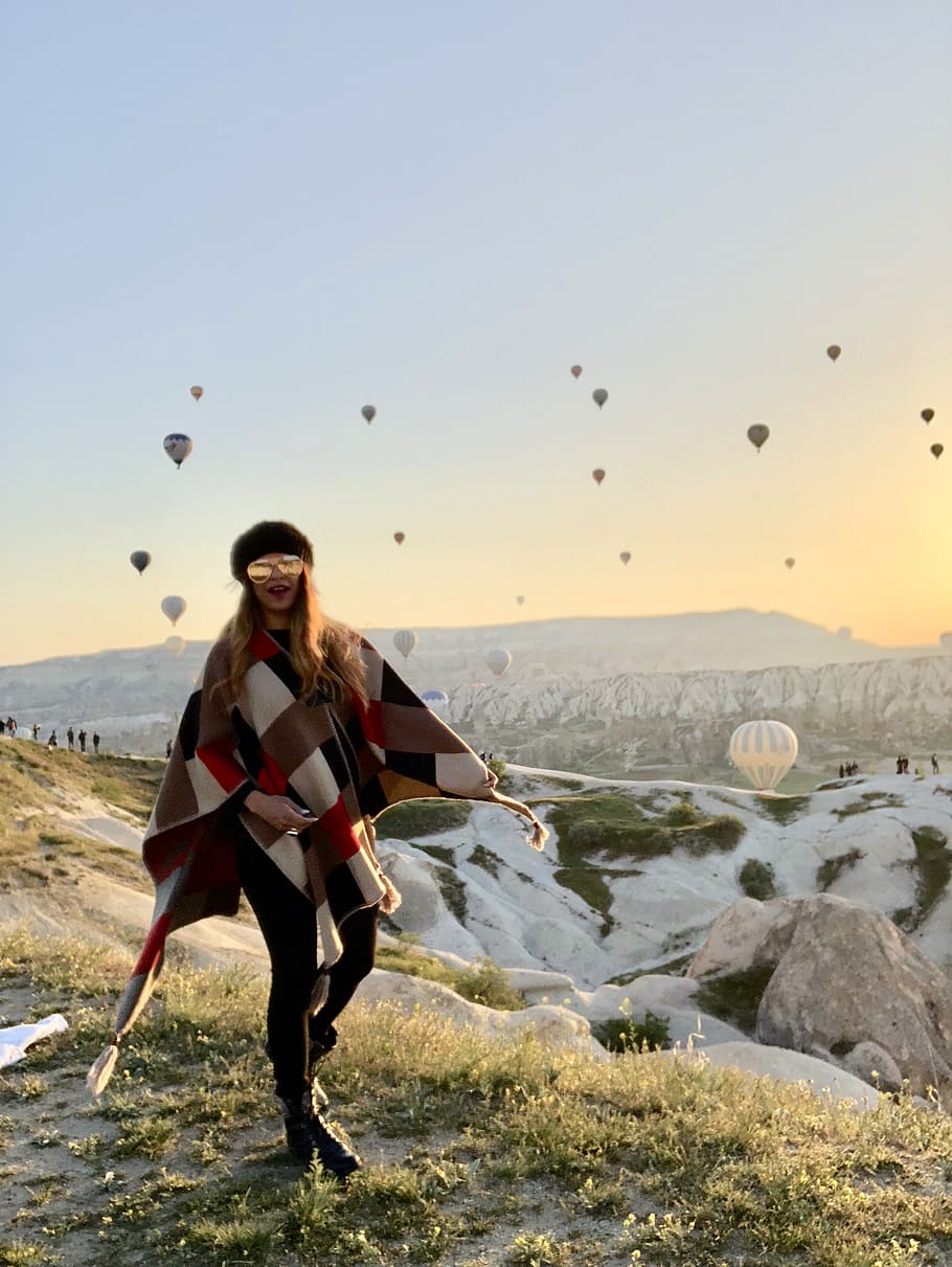 Woman Standing on Hill With Flying Hot-Air Balloons at the Back HD wallpaper