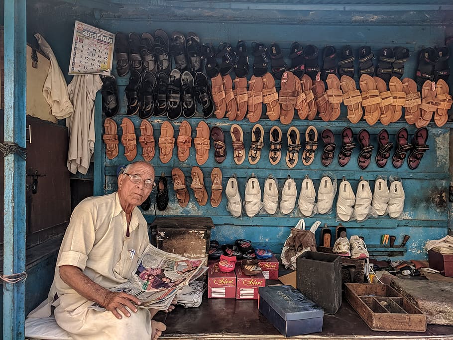 Man Reading Newspaper Surrounded by Shoes, adult, art, business, HD wallpaper