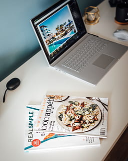 MacBook Pro beside magazines, laptop, electronics, computer, pc HD wallpaper