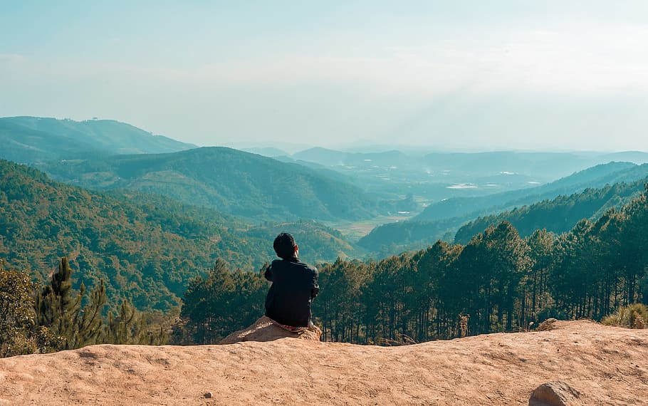 Man Sitting on Cliff Overlooking Mountain, clouds, daylight, edge HD wallpaper