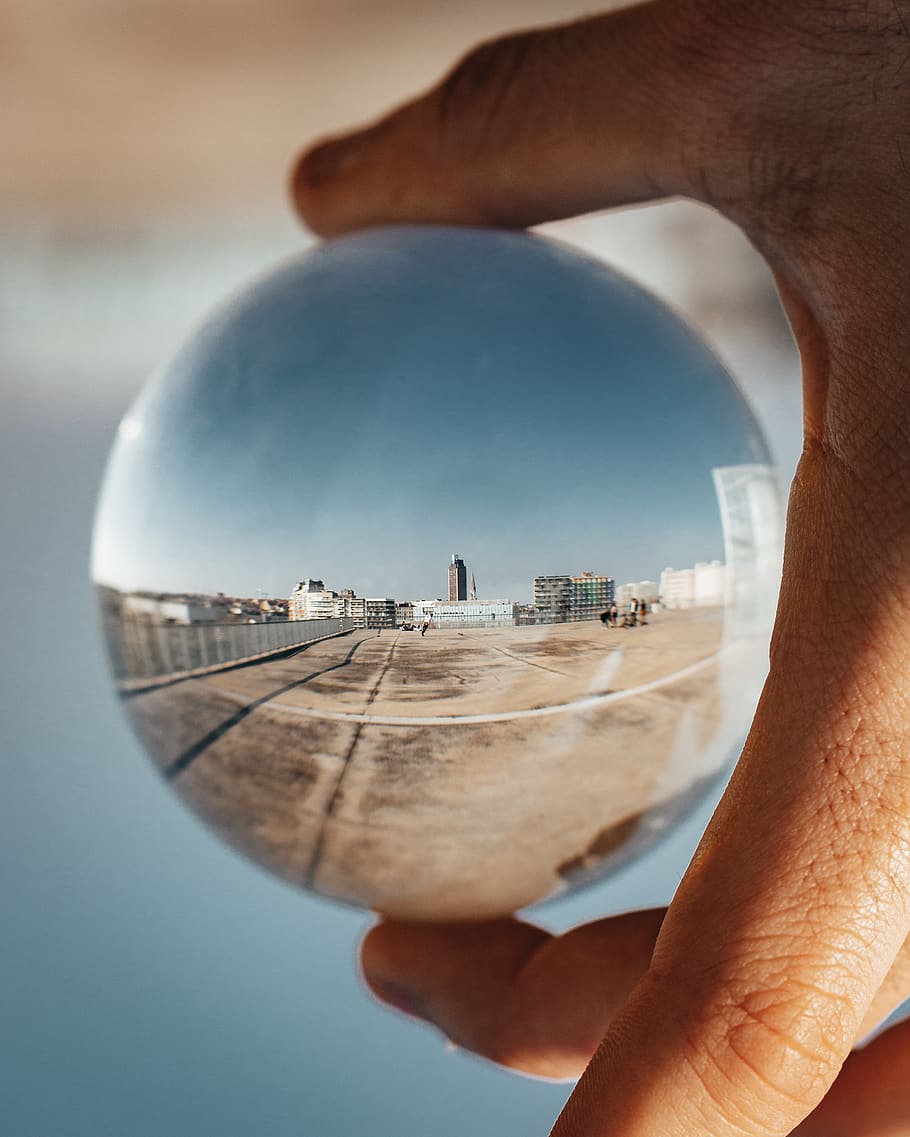 Person Holding Round Glass Ball, reflection, sphere, spherical HD wallpaper