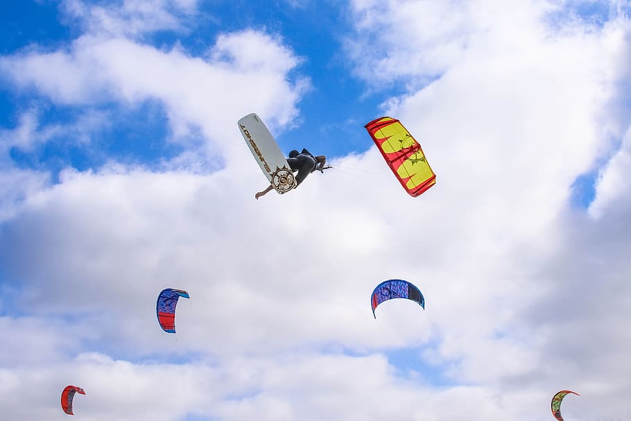 Multicolored Paragliding, clouds, colorful, daylight, high, kiteboarding HD wallpaper