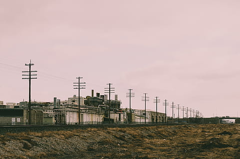 Line of Electric Post Near Concrete Building, cables, clouds HD wallpaper