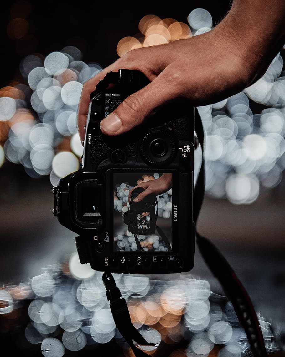 person holding DSLR camera while shooting white bokeh light, electronics, HD wallpaper