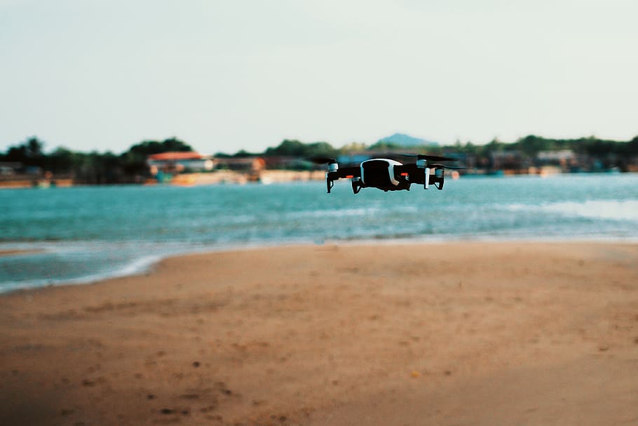 Black Quadcopter Drone On Flight, beach, camera, macro, ocean HD wallpaper