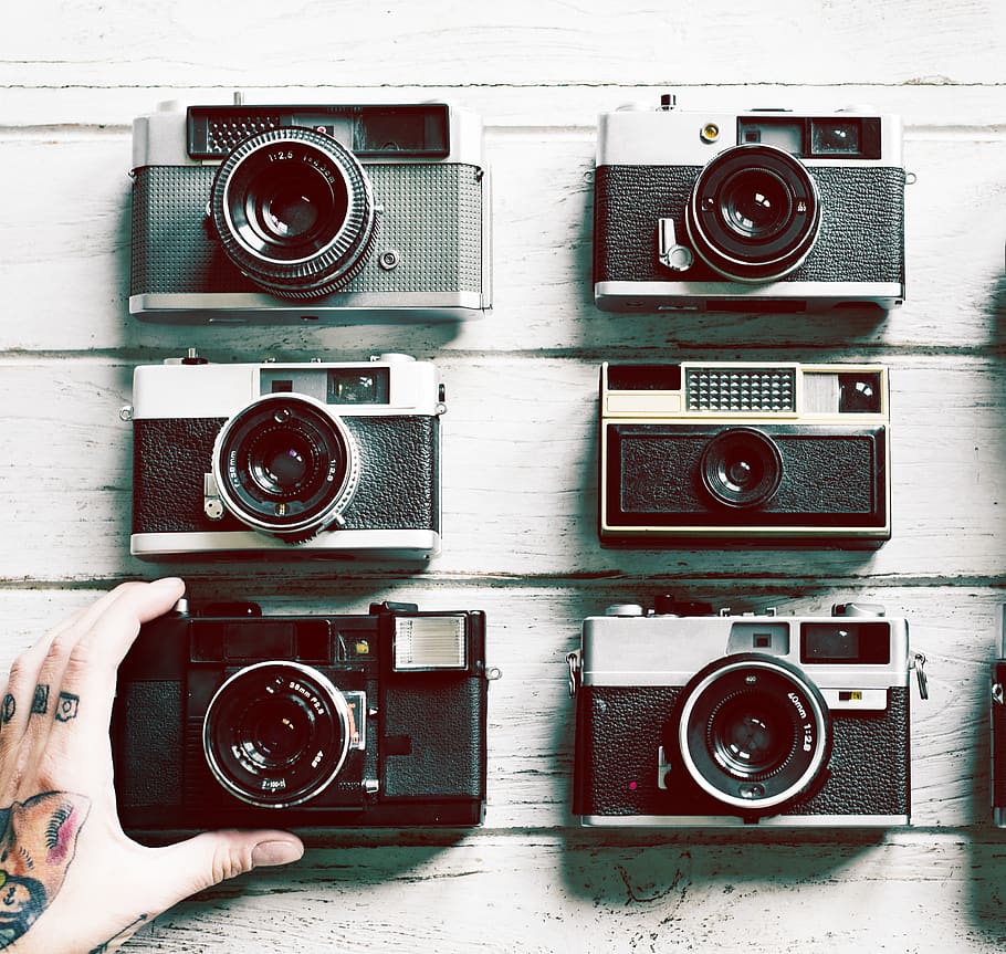 Six Black Cameras on White Surface, collection, equipment, hand HD wallpaper