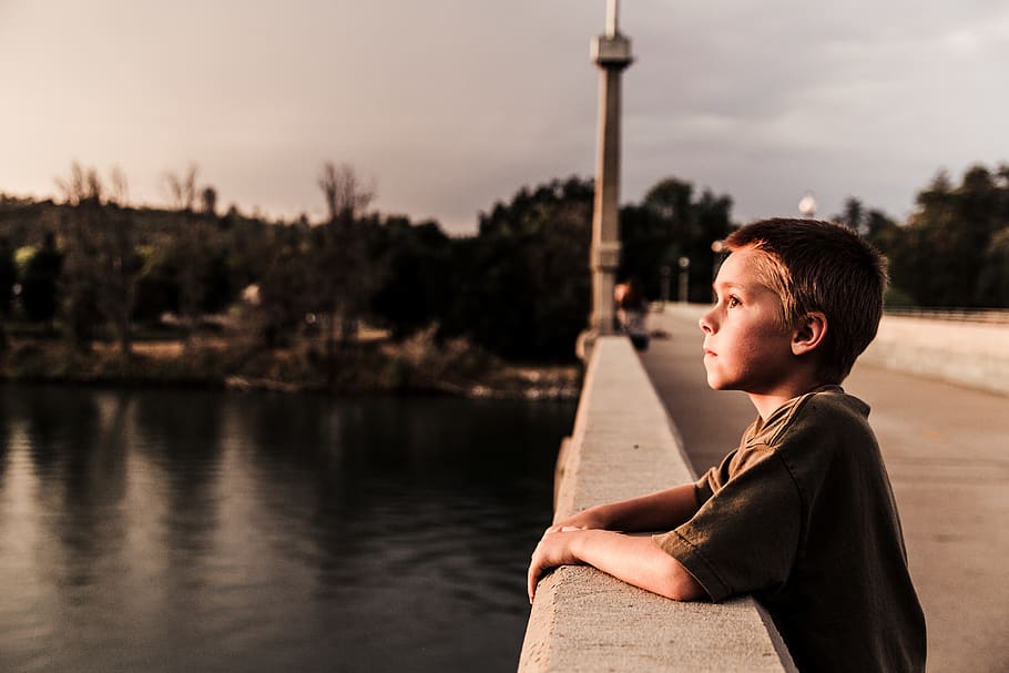 selective focus photo of boy at the bridge near body of water, HD wallpaper