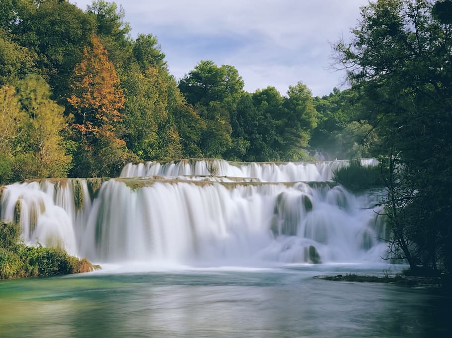 waterfalls with trees under cloudy sky, scenics - nature, beauty in nature HD wallpaper