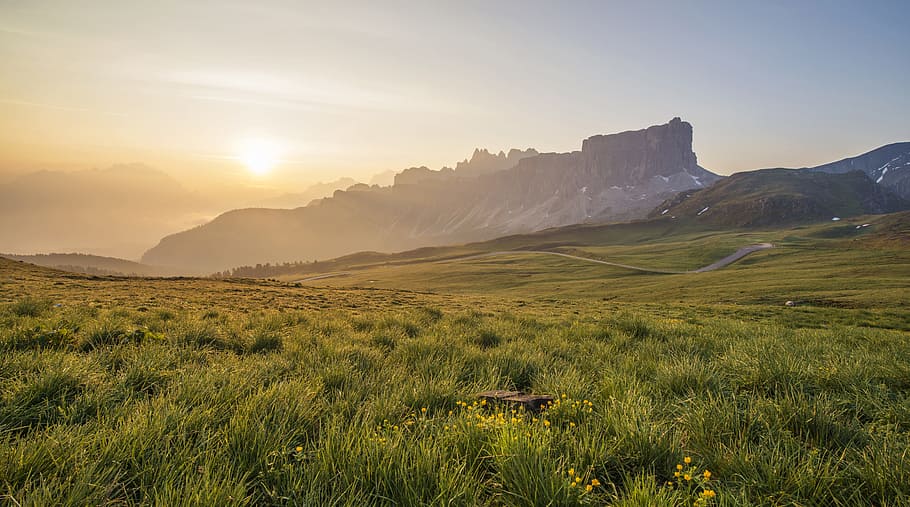 photo of green grass field at sunrise, mountain ridge, mountain range HD wallpaper