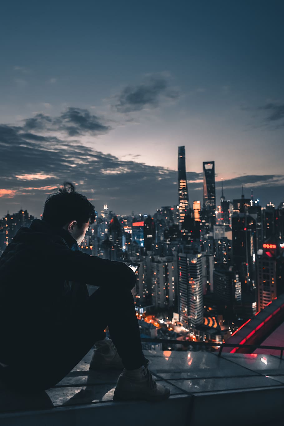man sitting on roof top during nighttime, person, human, metropolis