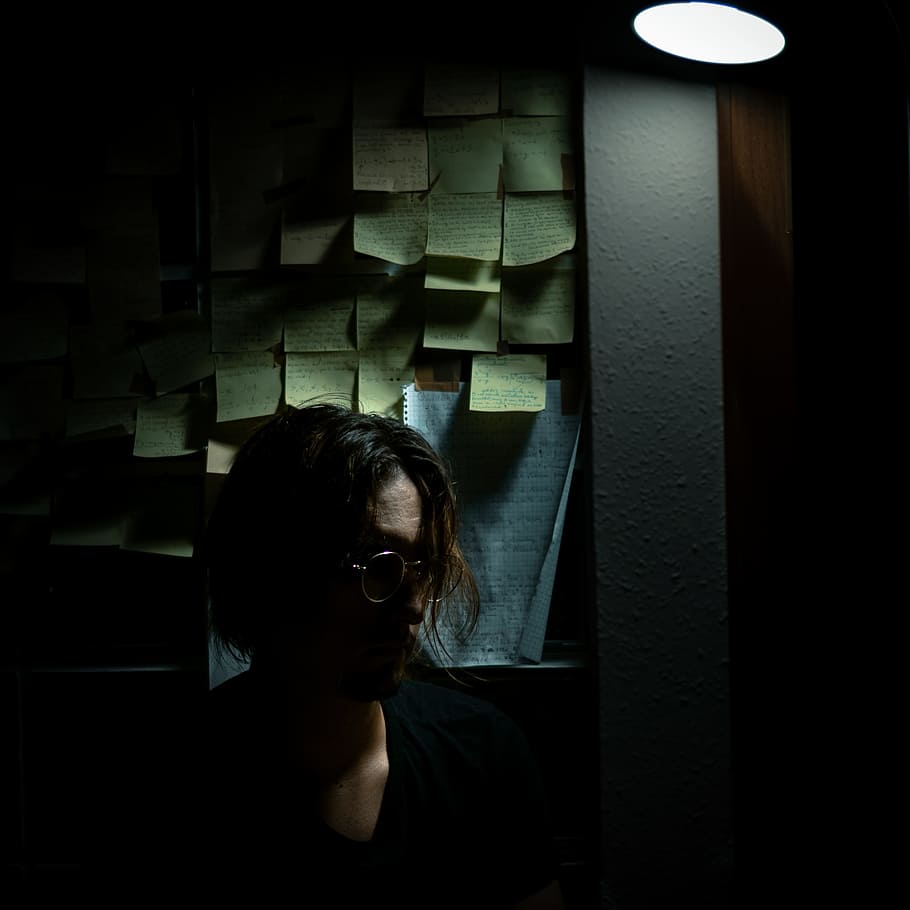 man standing near board, person, wall, post it, sticky note, dark HD wallpaper