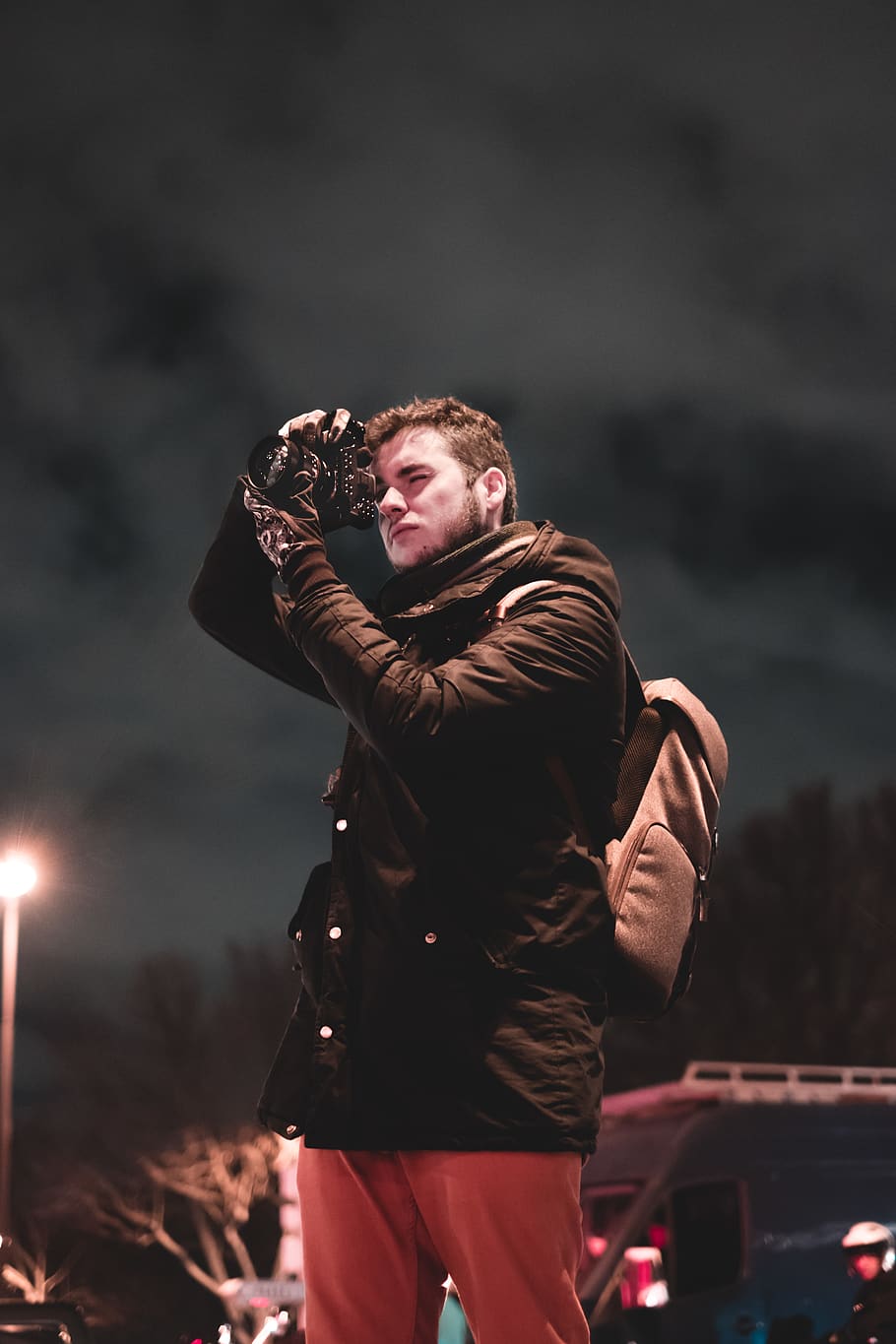 standing man while holding camera under gray sky, three quarter length HD wallpaper