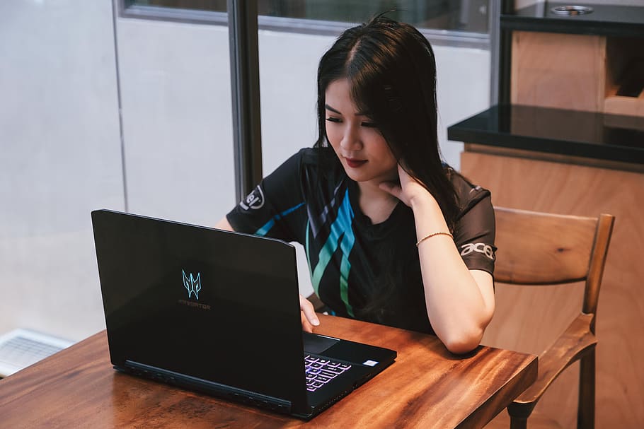 woman using laptop computer while sitting at the table, wireless technology HD wallpaper