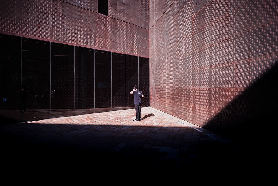 person standing between brown wall, one person, architecture HD wallpaper