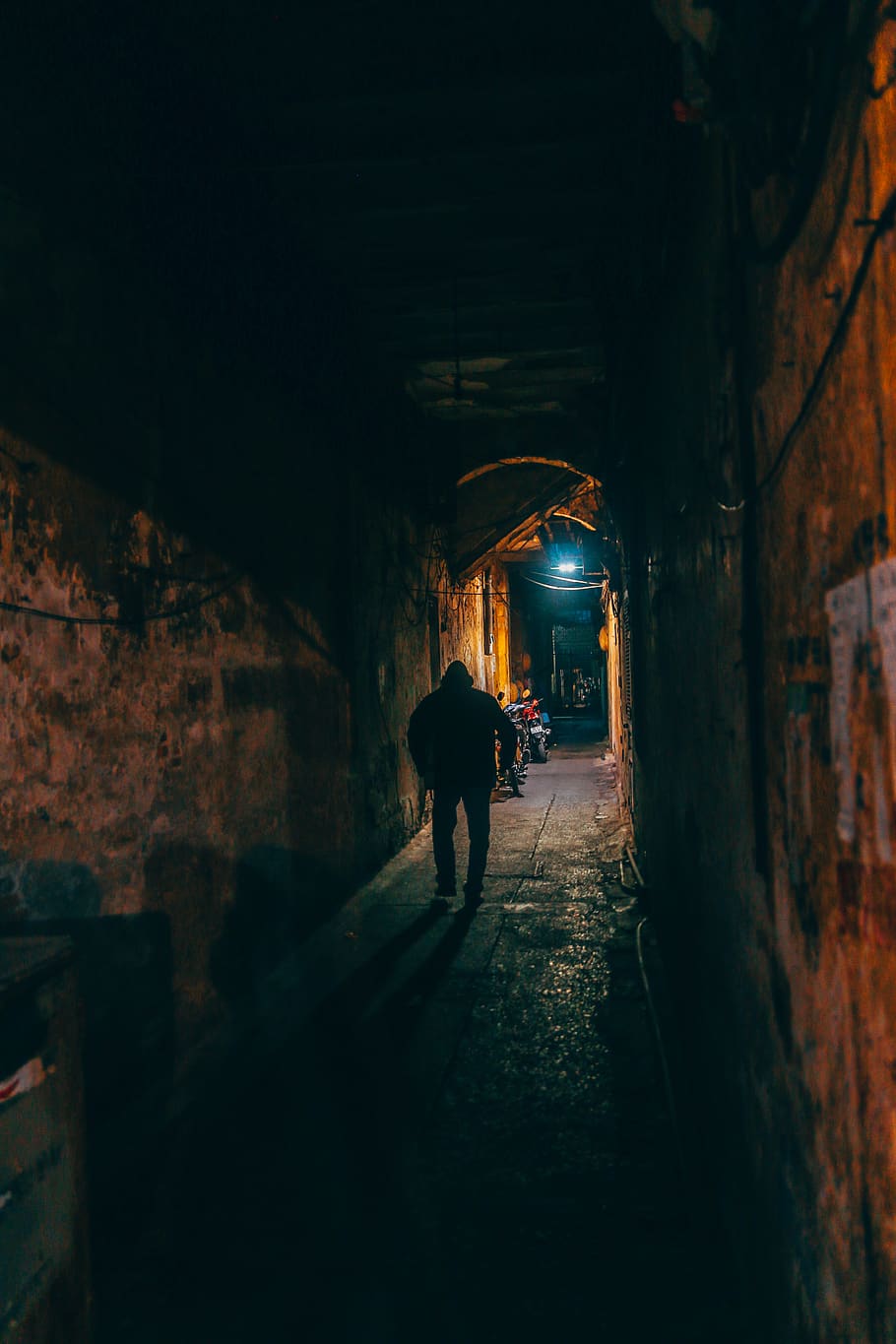 Photo of Person Walking Along Brown Wall Tunnel, dark, indoors HD wallpaper