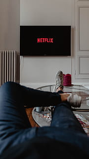 man lying on sofa infront of TV, leg, shoe, table, candle, television HD wallpaper