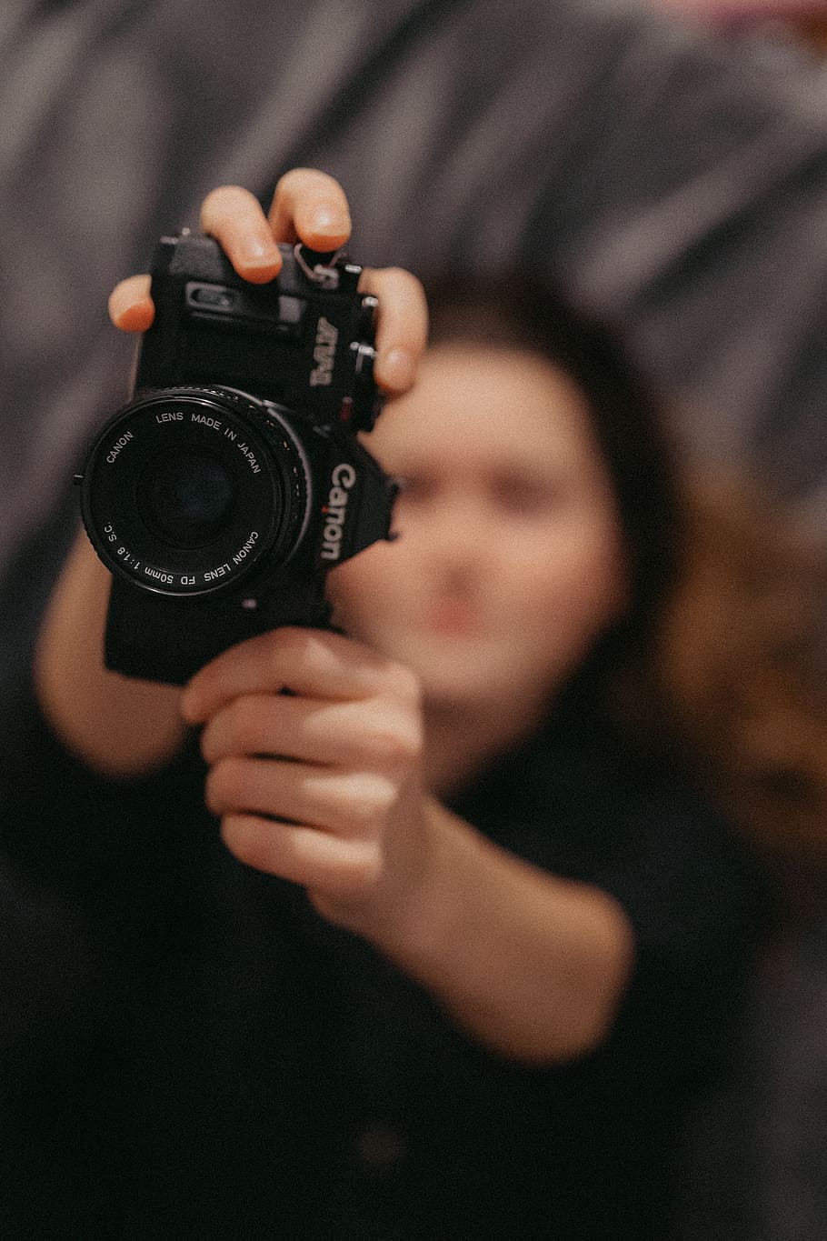 woman holding Canon film camera, electronics, person, human, finger