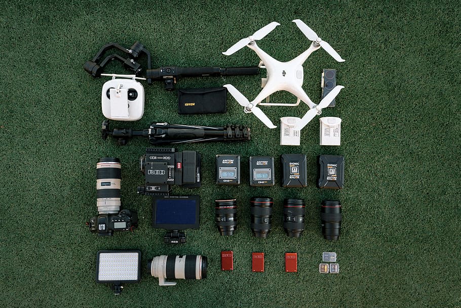 white quadcopter drone with DSLR camera set, lens, equipment