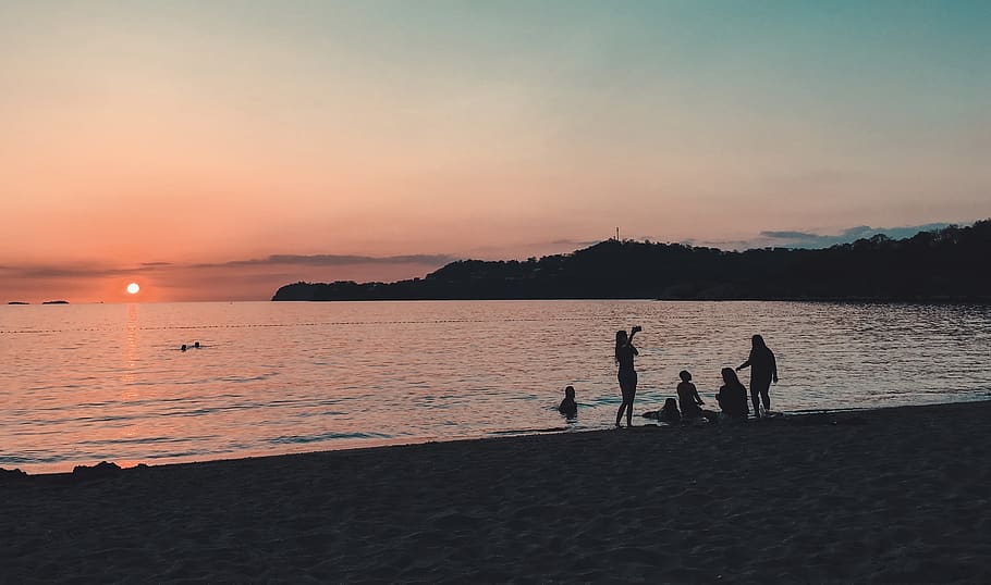 People Standing and Sitting on Seashore, beach, evening, landscape HD wallpaper