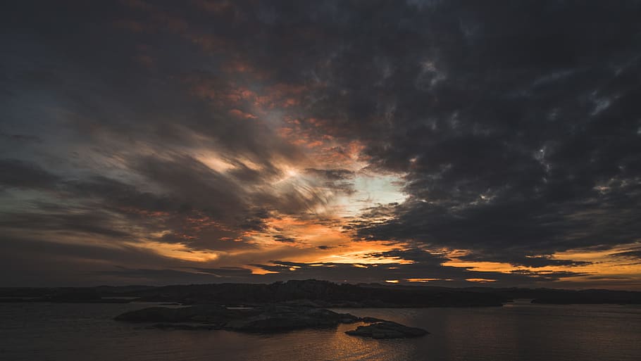 Silhouette of Island Under Grey Clouds during Golden Hour, backlit HD wallpaper